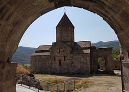 Photo by Hasmik Ghazaryan Olson brown concrete building near green grass field during daytime