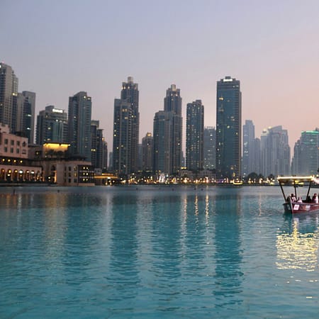 body of water with high-rise building in distance