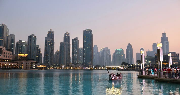 body of water with high-rise building in distance