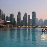 body of water with high-rise building in distance